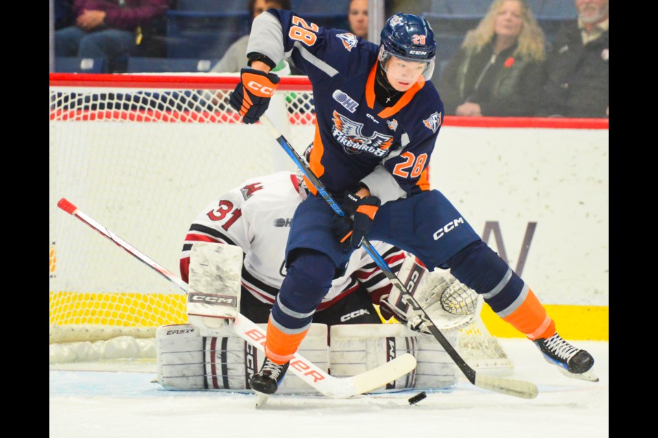 Matthew Wang of the Flint Firebirds tries to tip a point shot in front of the Guelph Storm net Friday at the Sleeman Centre.