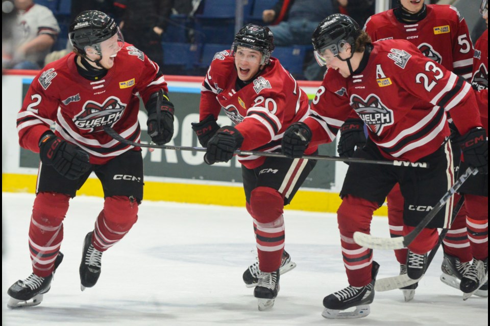 Rowan Topp, from left, Leo Serlin and Charlie Paquette are all smiles after Topp scored his first OHL goal Friday.