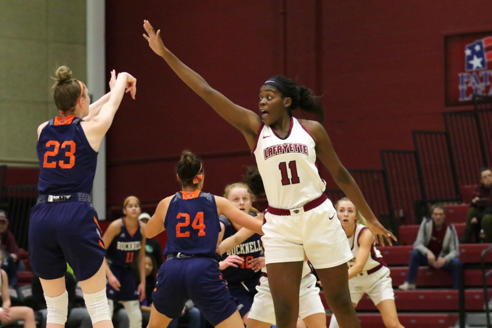 Naomi Ganpo (11) of the Lafayette Leopards reaches in an attempt to block a shot by Ally Johnson (23) of Bucknell during NCAA D1 women's basketball play in 2020. A Bishop Macdonell graduate, Ganpo has received increased playing time this year in her junior season. Submitted photo