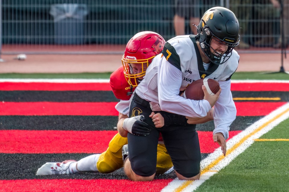 Quarterback Nolan Kaban (7) of the Waterloo Warriors is sacked in the endzone by linebacker Jack Cobb of the Guelph Gryphons for a safety during Guelph's Homecoming Game Saturday at Alumni Stadium. The Gryphons struck for a 42-25 victory in front of a crowd of 8,500.