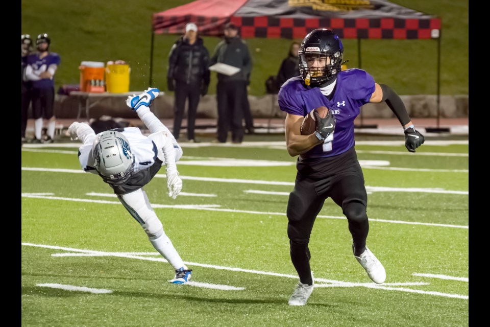 Matthew Stam, right, of the Centennial Spartans runs away from a Jacob Hespeler Hawks defender during the CWOSSA high school football championship game last month at the University of Guelph's Alumni Stadium.