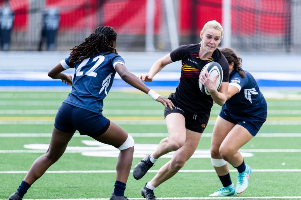 Kyla Warren carries the ball in this OUA women's rugby contest between the Guelph Gryphons and Toronto Varsity Blues.