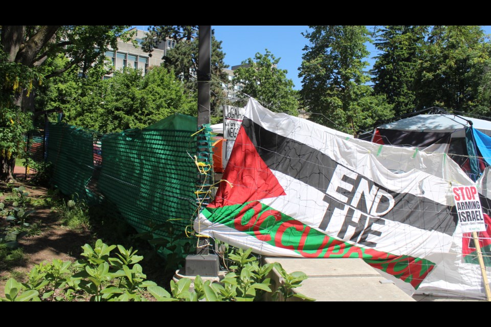 Green fencing was installed by the University of Guelph after it ordered an encampment to move belongings so a safe evacuation route for people inside Zavitz Hall can be unobstructed.