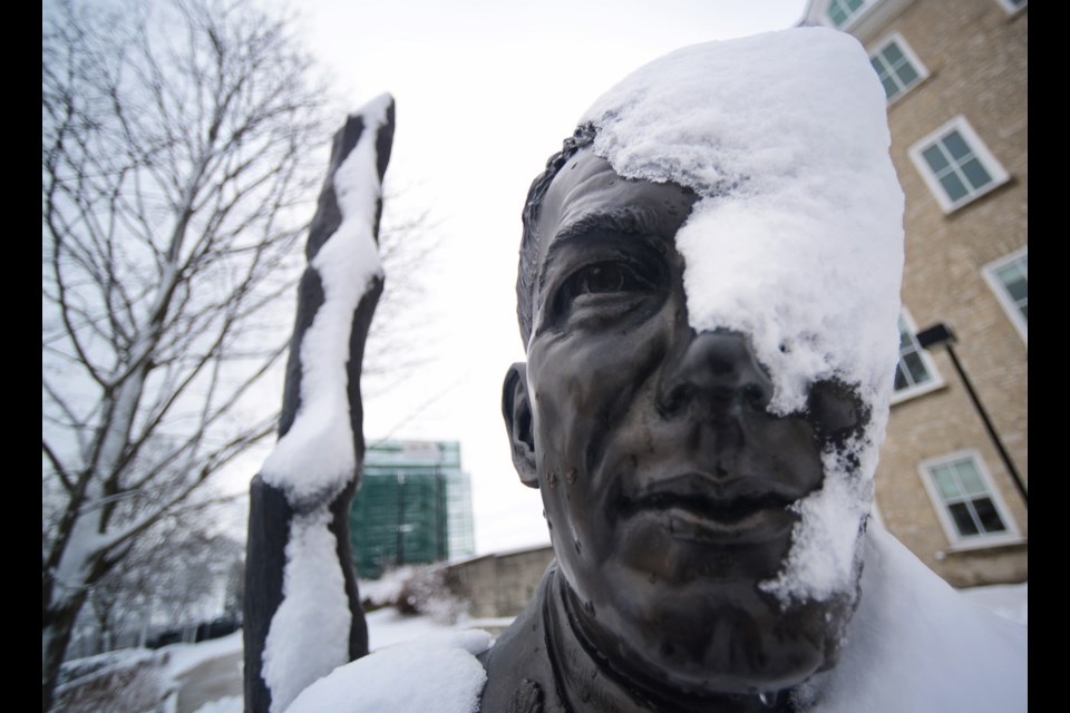 John McCrae's statue outside the Guelph Civic Museum stoically handles a last blast of winter Sunday morning. Tony Saxon/GuelphToday