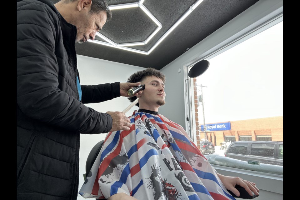 Adam Tabal in action at the Arthur Barbershop.