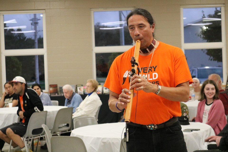 Christin Dennis played an Indigenous wooden flute while walking through the crowd. 