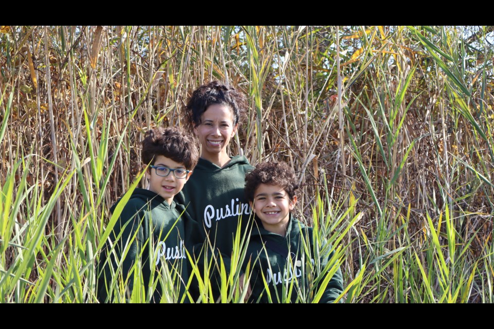 The phragmites at Little Lake tower over Daniela and her sons. 