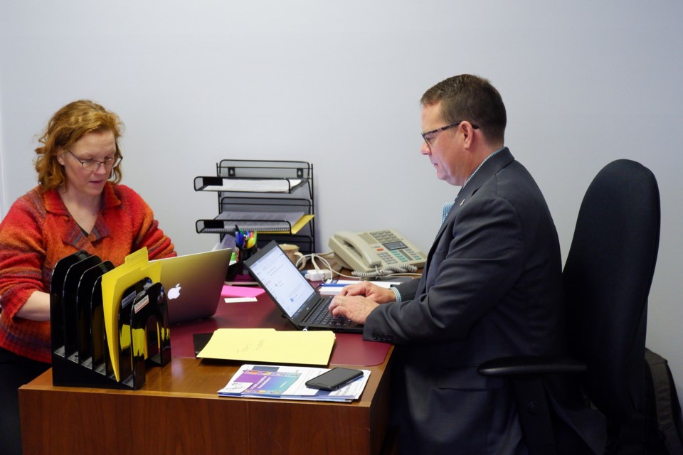 Candice Lepage provides Mike Schreiner with a news brief. Anam Khan/GuelphToday