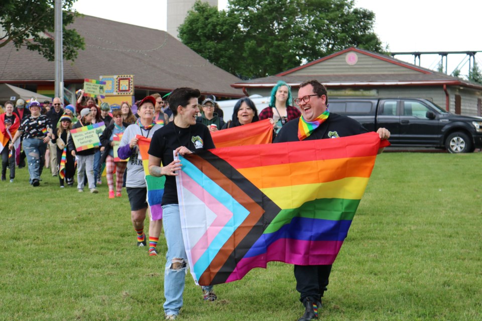 Members of Minto Pride lead the Pride march in Palmerston Lion's Heritage Park.