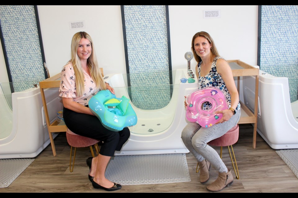 Calming Cove Baby Spa founders Hillary Spurr (left) and Shari Snow with the small hydrotherapy tubs.