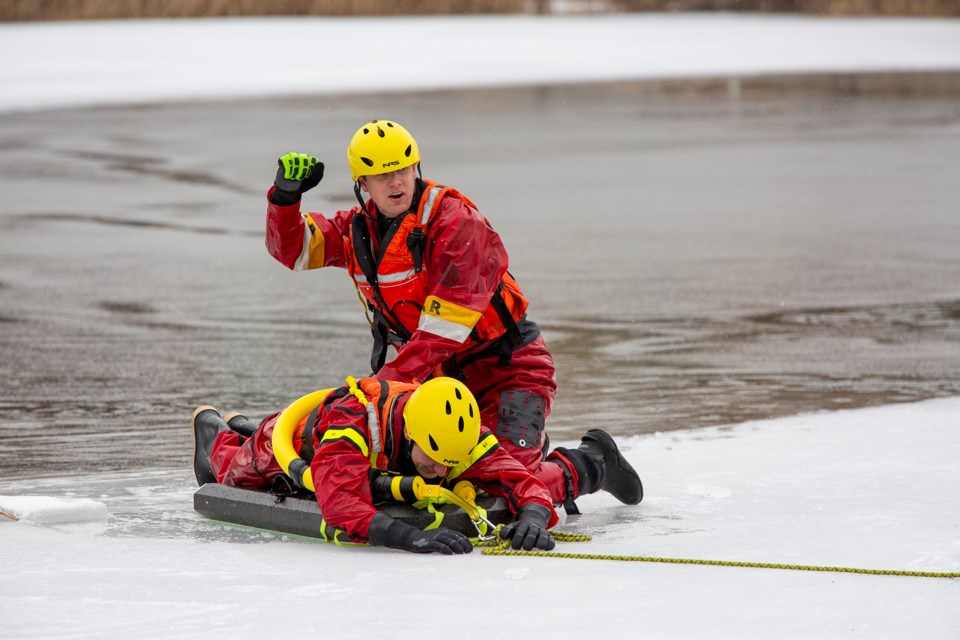 Jesse Bean (top) gets Scott Slater ready to be hauled to shore after a successful ice water extraction during the Halton Hills Fire Department's training this week at Fairy Lake in Acton.