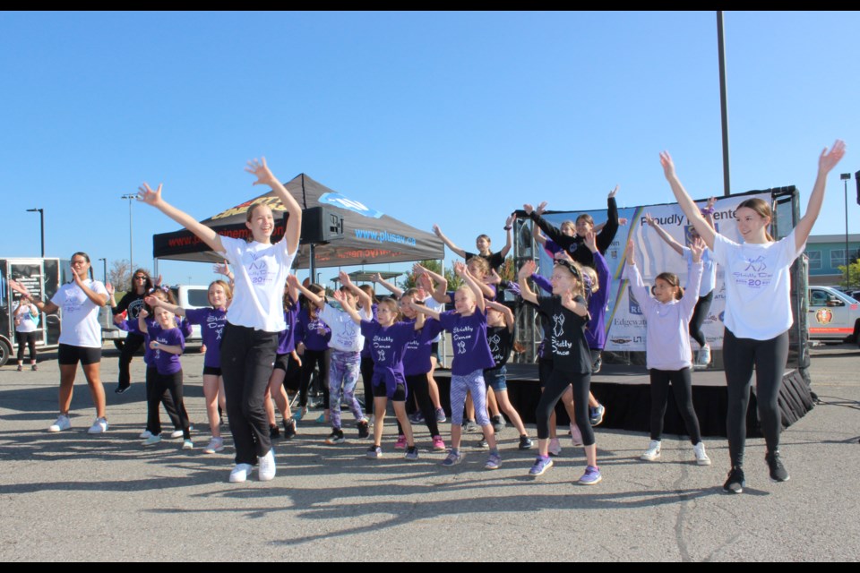 The Strictly Dance crew leads the crowd through a warm up at the Walk or Run for Georgetown Hospital.