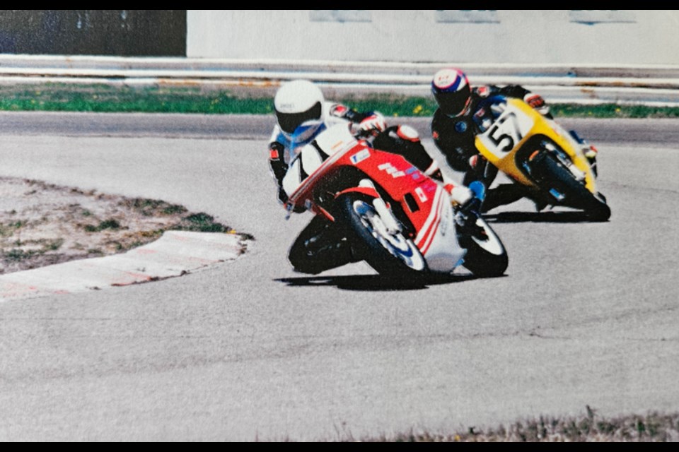 Ken Hodge takes a corner at Shannonville Motorsport Park with son David right behind him. Along with Don Hodge, the team's mechanic, the trio dominated the vintage motorcycle racing circuit.