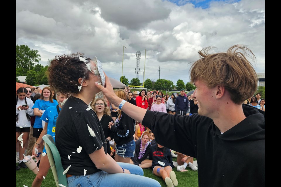 Christ the King teacher Melissa Fiorelli takes a pie in the face from CtK student Luka Zelek as part of the school's Relay for Life fundraising efforts.