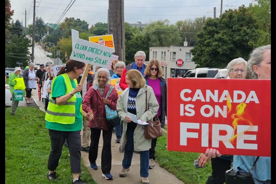 Attendees of the community rally march down Guelph Street Tuesday.