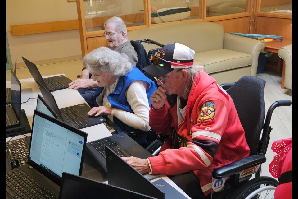 Bennett Centre residents (from front to back) Gerry Stoyles, Patrica Godden and Bill Dinsmore try out the new laptops donated by Gore Mutual Insurance Friday.