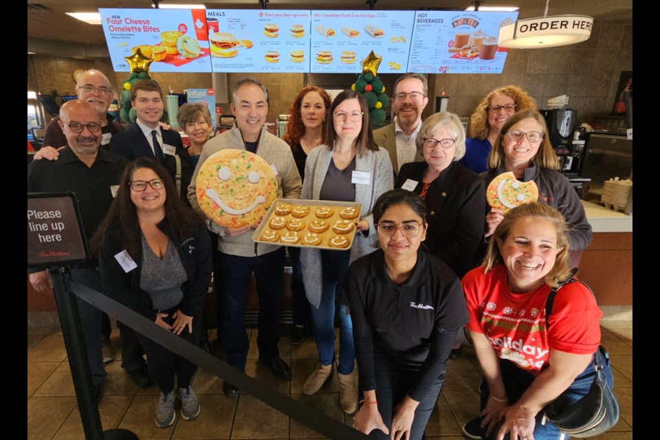 Georgetown South Tim Hortons employees, members of Halton Hills Council, the Chamber of Commerce and representatives of Food4Kids Halton kick off the sales of Smile Cookies at Tim Hortons.