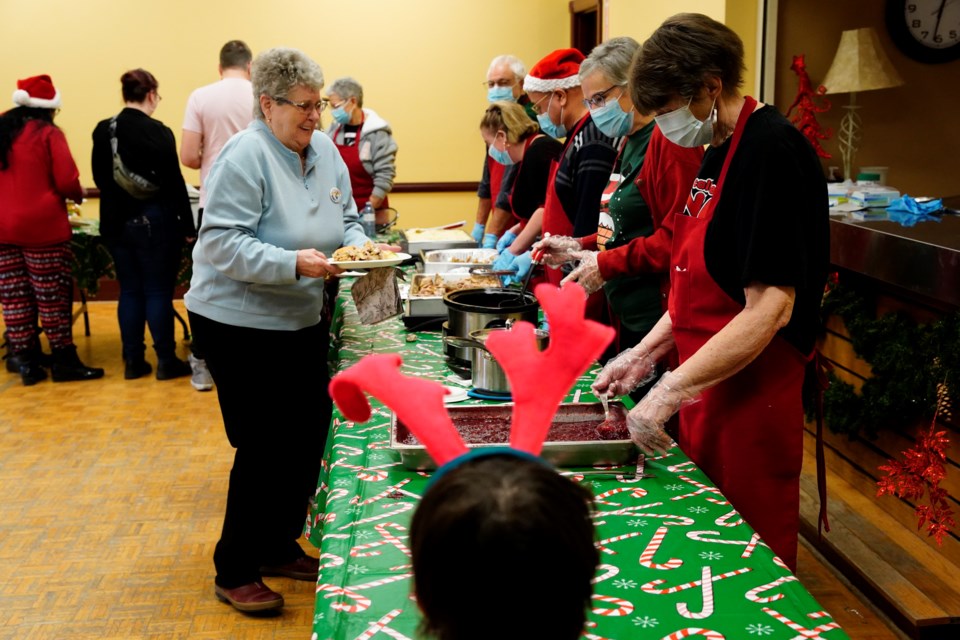 Volunteers serve up a Christmas feast at the Acton Town Hall Centre.                   