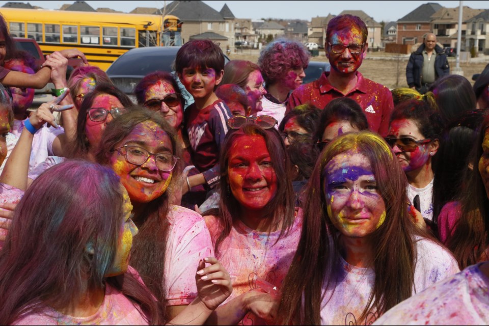 Aditee Goswami (centre) and some fellow celebrants were caked in Holi colours by the end.