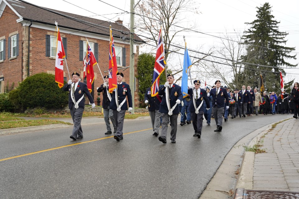 The Royal Canadian Legion colour party leads the way as the Remembrance Day parade steps off towards the Glen Williams cenotaph.