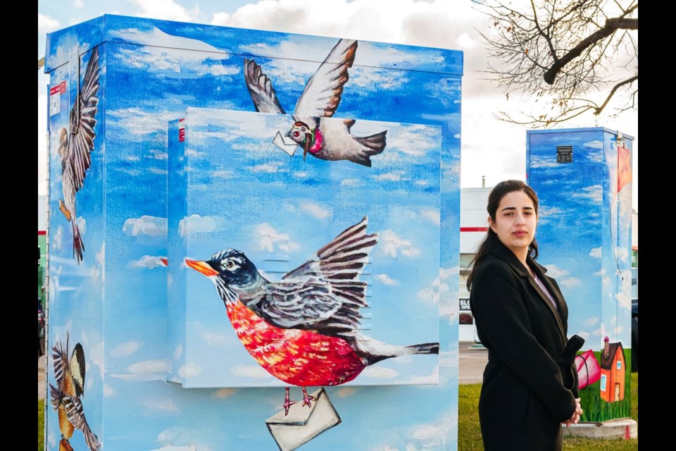 Hope Flynn with Postal Wings, located on the corner of Guelph Street and Sinclair Avenue.