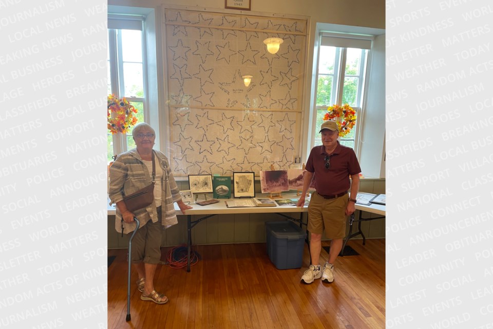 Mary Shier and John McDonald standing in front of a heritage quilt from 1945 and sharing information about the lime industry’s early beginnings in Limehouse in the mid 1800s at Limehouse Memorial Hall.