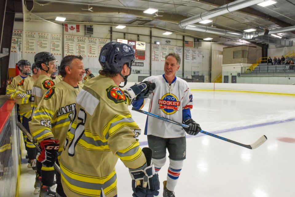 The Pro Hockey Hero players greeted all of the Halton Hills firefighters hockey team at the start of the game. The friendly match held yesterday at Mold-Masters SportsPlex raised money for the Canadian Cancer Society.