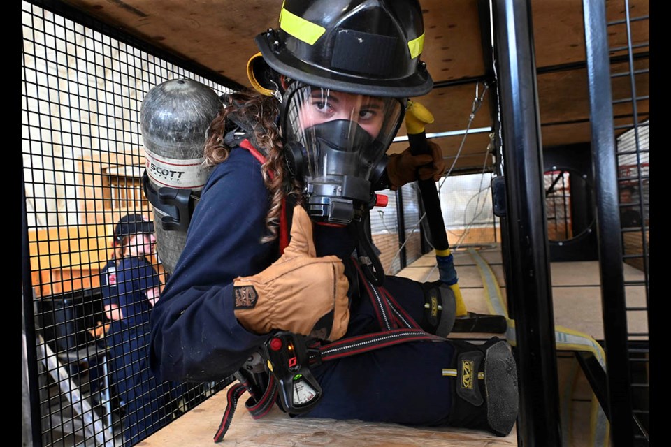 Ava Lema of Georgetown gives the thumbs up as she navigates a confined space with hazards to conduct a rescue of a trapped mock victim at Blaze Fire Academy.