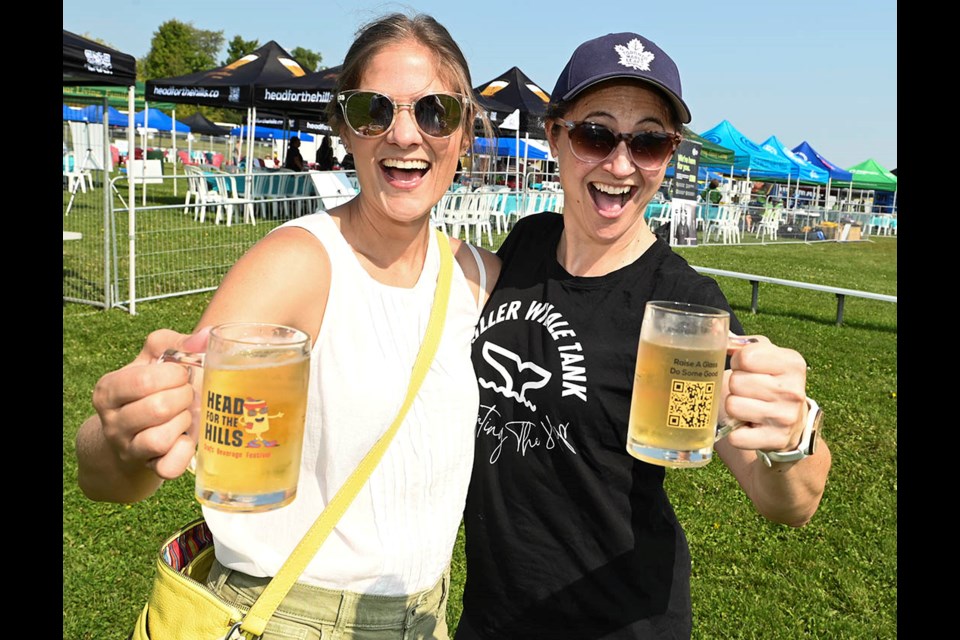 Cheers! Whitney Johnston, left, and Kathy Cates enjoy some ice cold drinks at the eighth annual Head for the Hills Craft Beverage Festival.