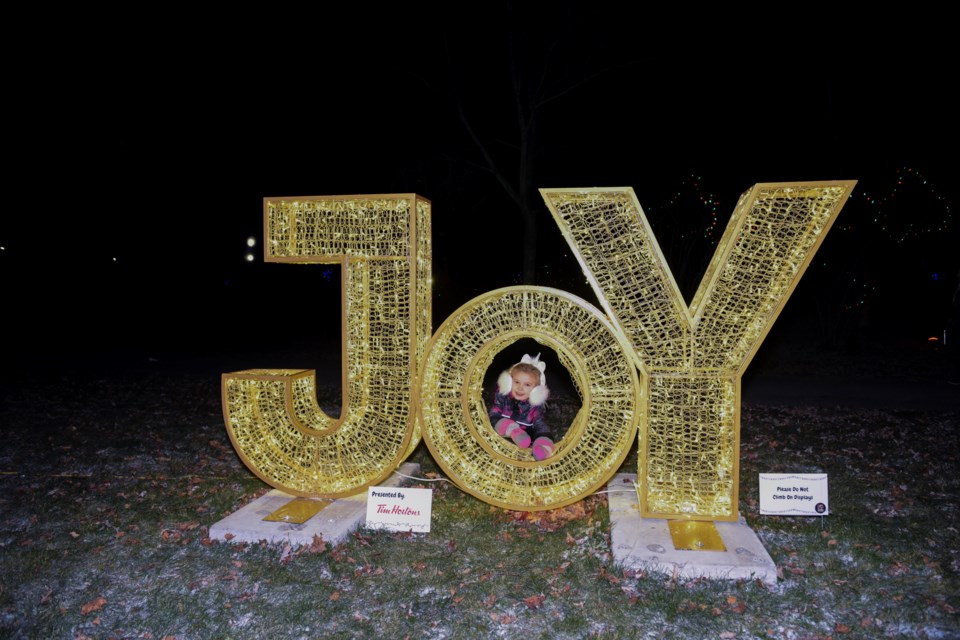 Julia finds a picture-perfect spot in one of the many festive decorations at Dominion 
Gardens Park.