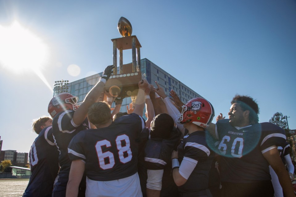 Members of the Georgetown 87s lift the Halton football tier 1 championship trophy after beating Nelson 28-11 for the school's first title since 1974.