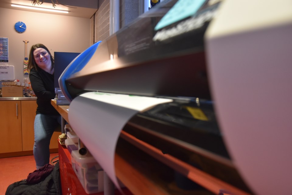 Melissa Harris, the Innisfil ideaLAB and Library's creative making and discovery manager, sites near a HackLAB printer. 