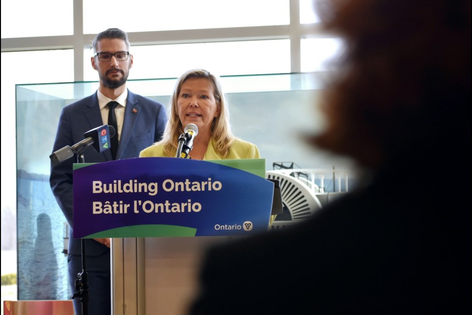 Innisfil Mayor Lynn Dollin speaks as Matthew Rae, parliamentary assistant to Ontario's minister of municipal affairs and housing, looks on. The town received $2.52 million April 2 for exceeding its 2023 housing target.