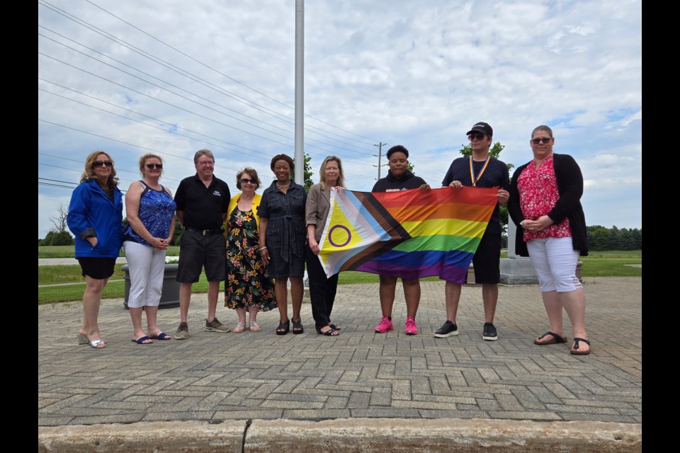 Dignitaries with the Intersex Progress Pride flag outside Innisfil town hall  June 13. 