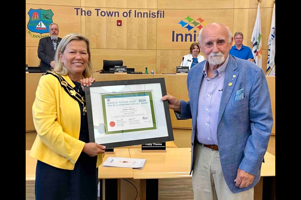 Innisfil Mayor Lynn Dollin presented Al Gilchrist with the 2024 Ontario Senior of the Year Award at town hall June 24. 