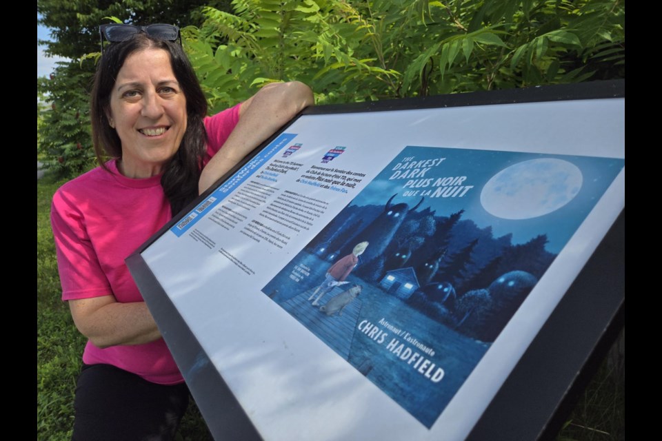 Innisfil ideaLAB and Library communications and events manager Wendy Ricciardi with a Storywalk board. 