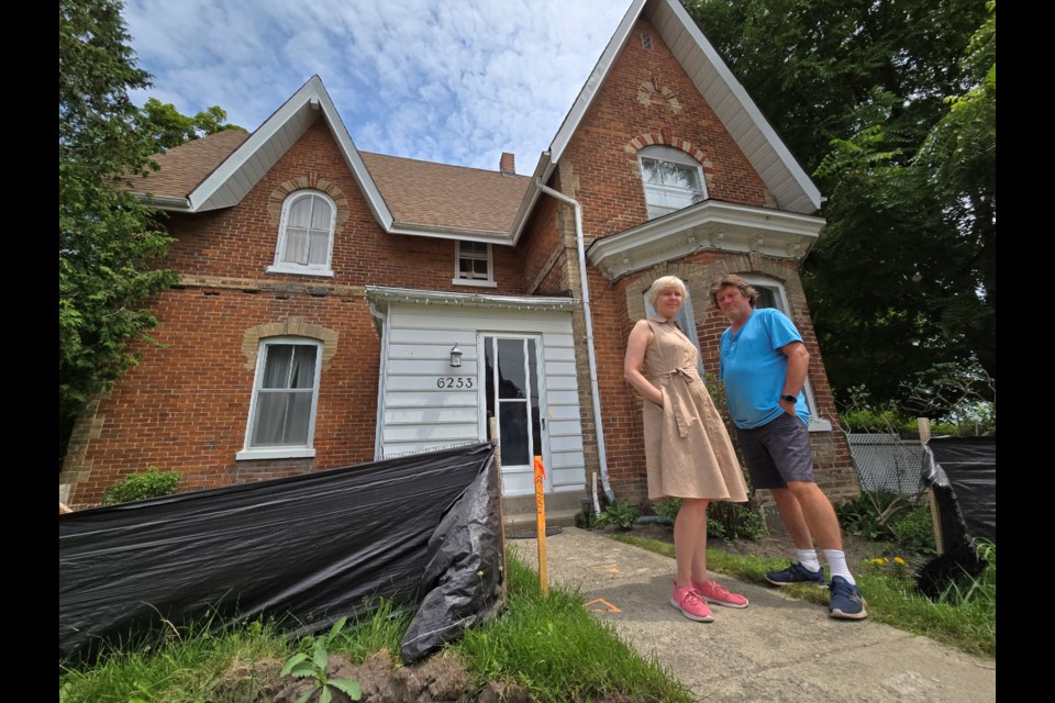 Rev. Krista Moore and her husband, Steve Woods, outside the manse in Churchill. 