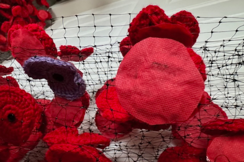 Marilyn Sehn ran into some difficulty when she tried to affix the poppies to the netting. After troubleshooting, she figured it out.