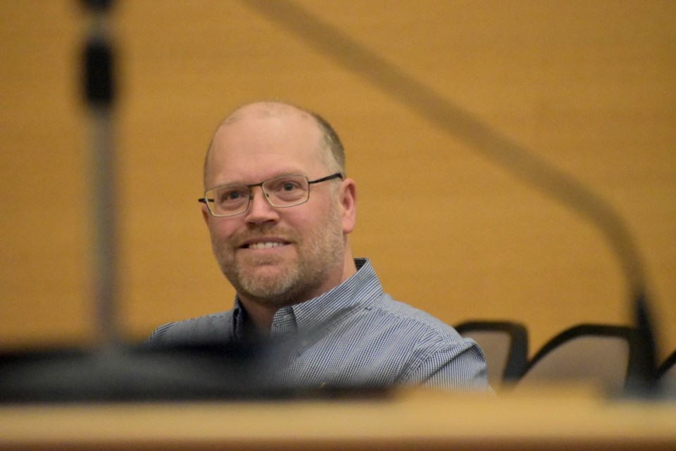 Handyman Bill Murray smiles while Innisfil Mayor Lynn Dollin speaks about him during a ceremony at town hall Dec. 17.