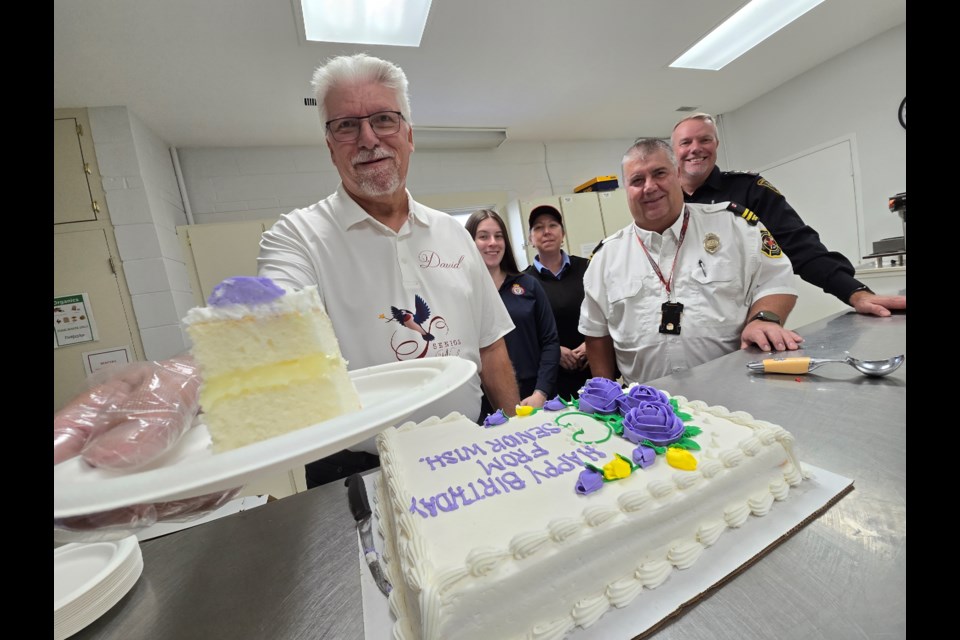 Volunteer David Niven and members of local emergency services gave out cake at the Senior Wish Association birthday bash at Sandycove Acres on Oct. 8. 