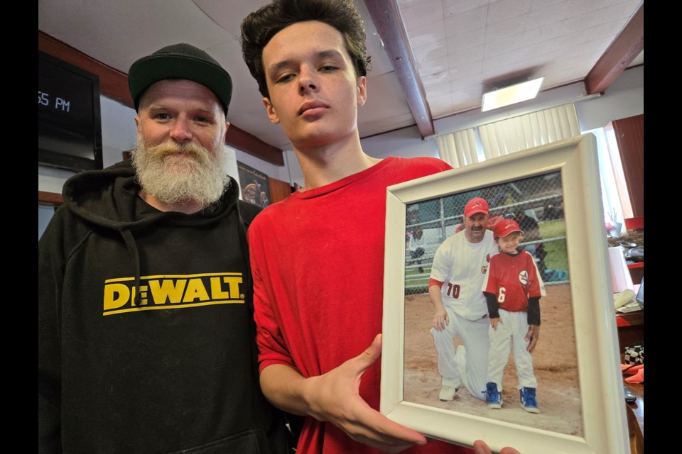 Bennie Dunsmoor, left, with his son, Joseph. Bennie's father, Brad, coached Joseph's baseball team about a dozen years ago.