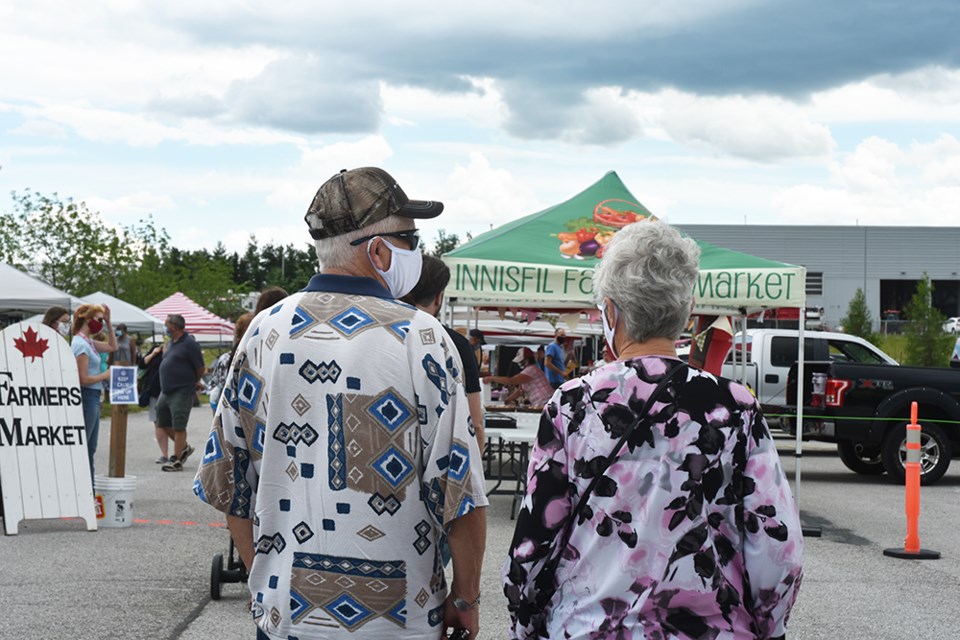 Waiting patiently to enter the  Innisfil Farmers' Market on Opening Day. Miriam King/Innisfil Today