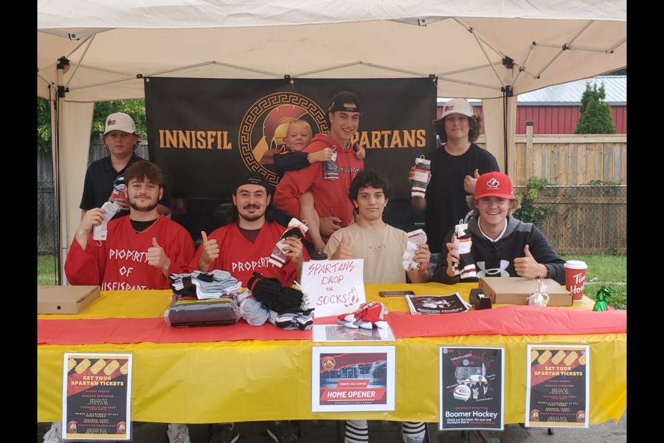 Innisfil Spartans hockey team collected six bags full of socks for local youth in need at the Innisfil Farmers' Market on Aug. 25