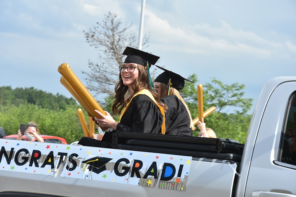 Grads are all smiles, in Nantyr Shores Secondary School's Grad Parade.