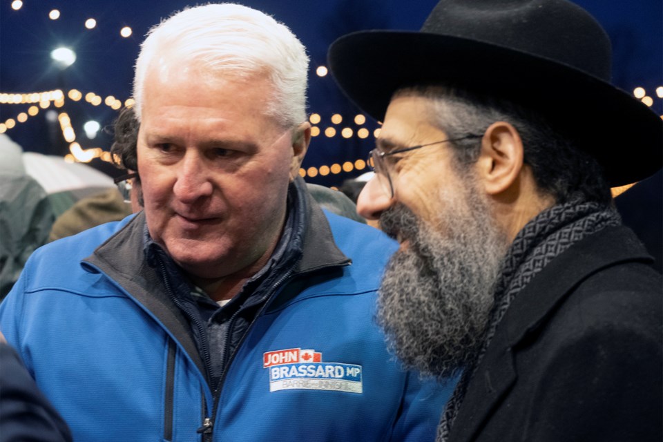 Barrie-Innisfil MP John Brassard and Rabbi Kaplan Sr. chat with members of the crowd.