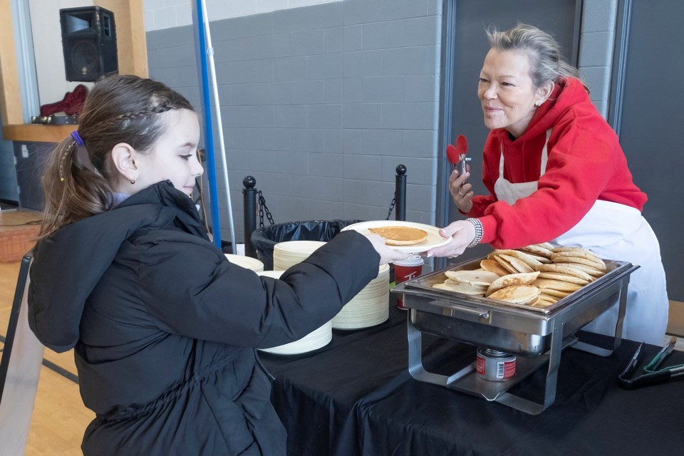 Emma Morsillo accepts a plate of pancakes from Mayor Lynn Dollin during Breakfast with Council on Saturday at the Innisfil YMCA.