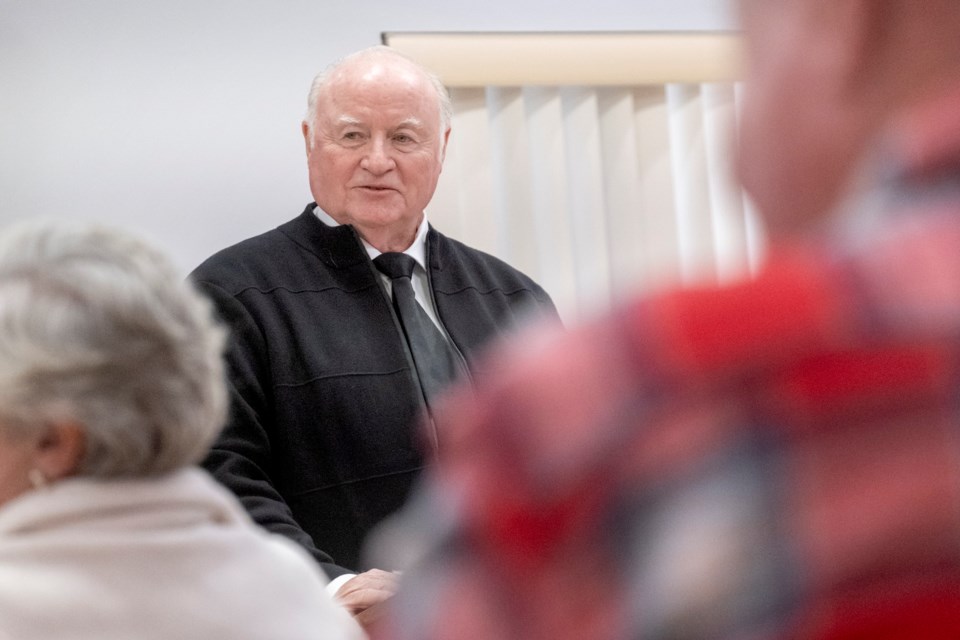 Dr. Tom Armstrong listens as his wife Deborah elaborates from the audience on one of his story points.