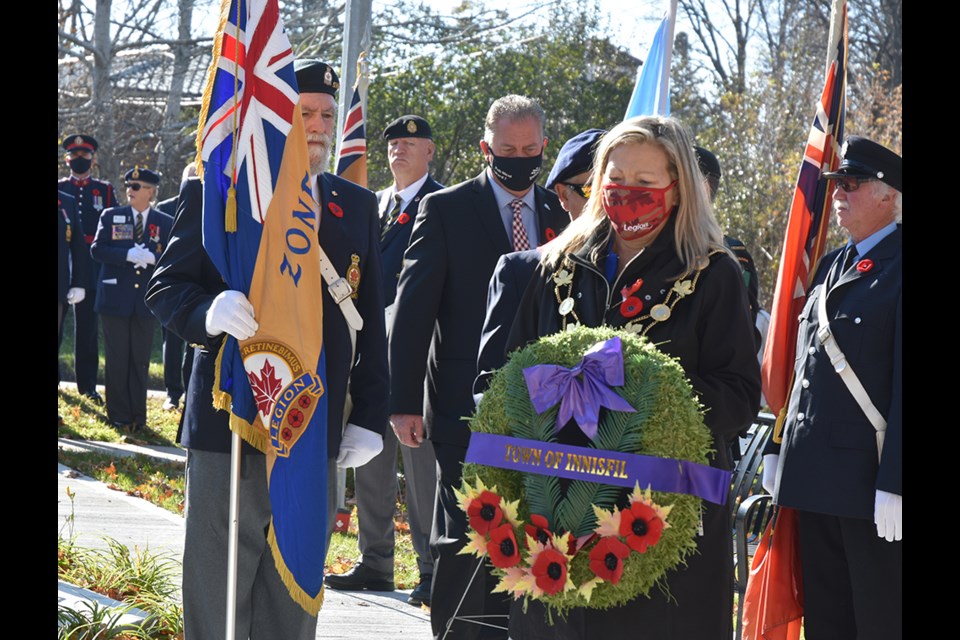 Innisfil Mayor Lynn Dollin prepares to lay a wreath at the Cookstown Cenotaph. 