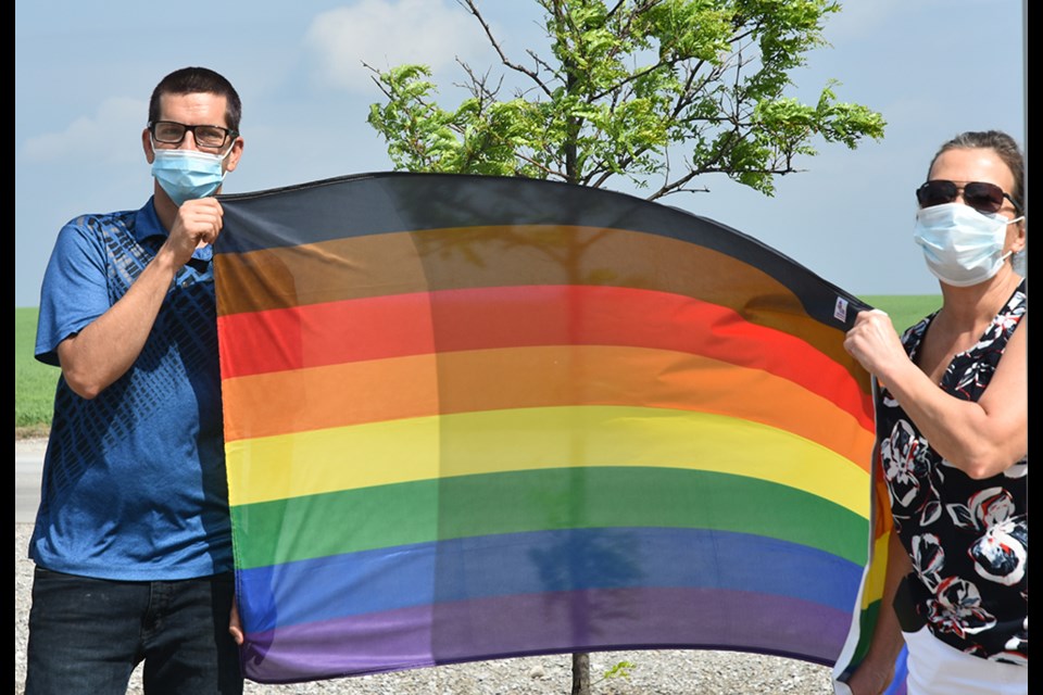 Jake Tucker of Innisfil Pride joins Innisfil Mayor Lynn Dollin, with the Rainbow Flag. Miriam King/Innisfil Today