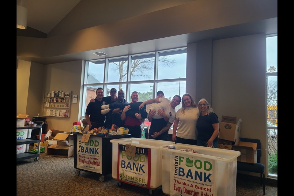 Firefighters and Innisfil Food Bank representatives teamed up to sort donations recently. 